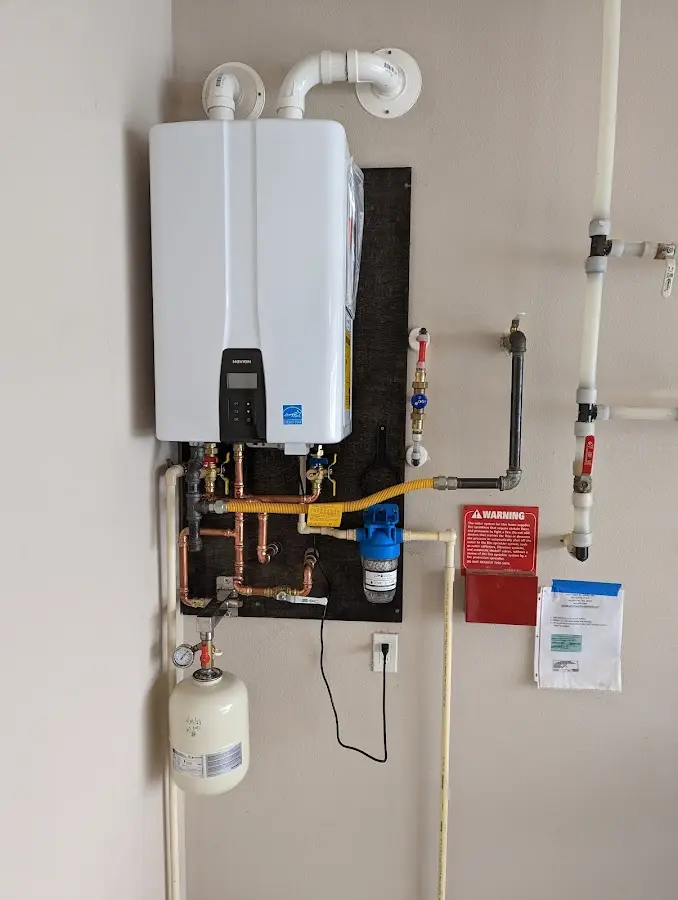 Professional plumber installing copper piping in a Dandridge home